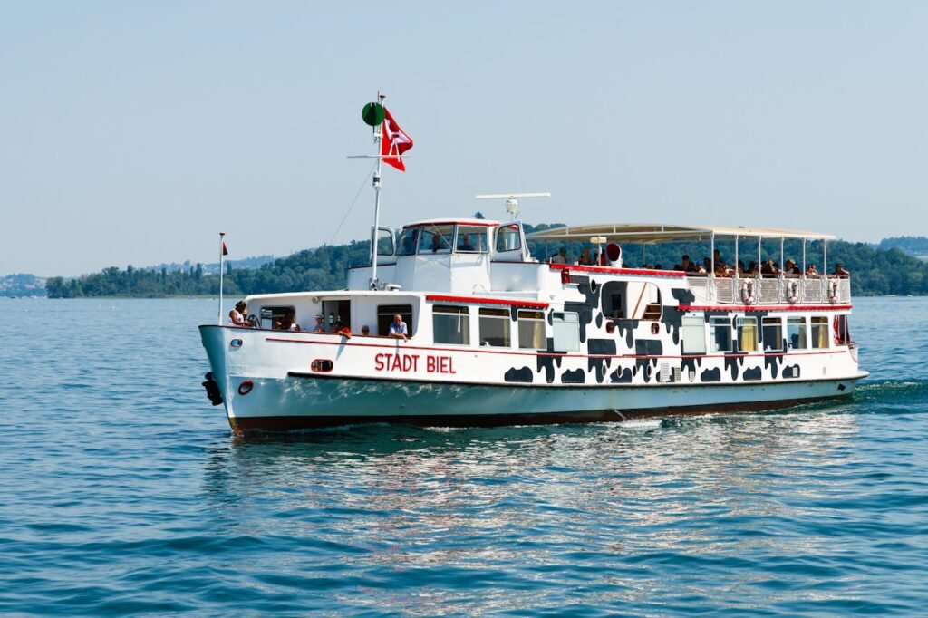 Stadt Biel ferry cruising on Lake Biel under a clear sky with passengers on board.